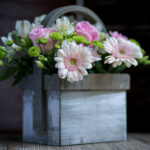 Flower Arrangement with Pink Gerberas and Roses in a Wooden Basket