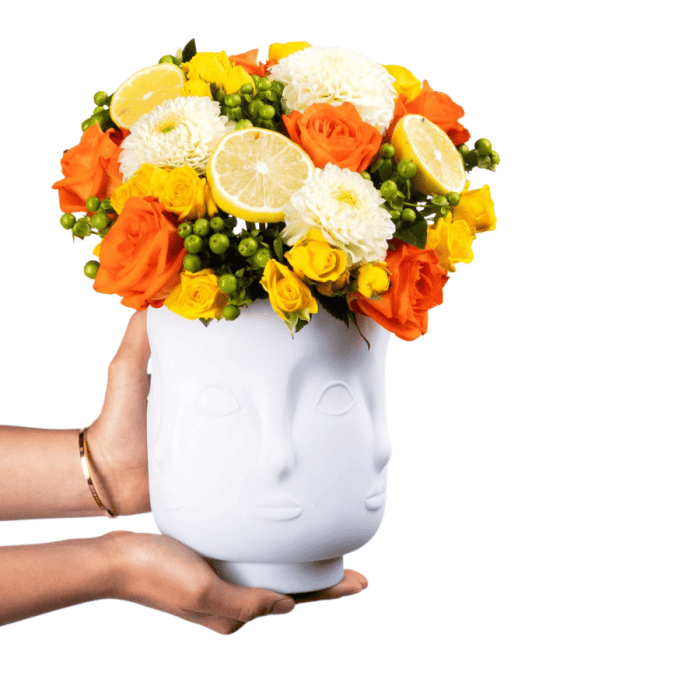 Floral Arrangement with Yellow-Orange Roses in White Glass Case